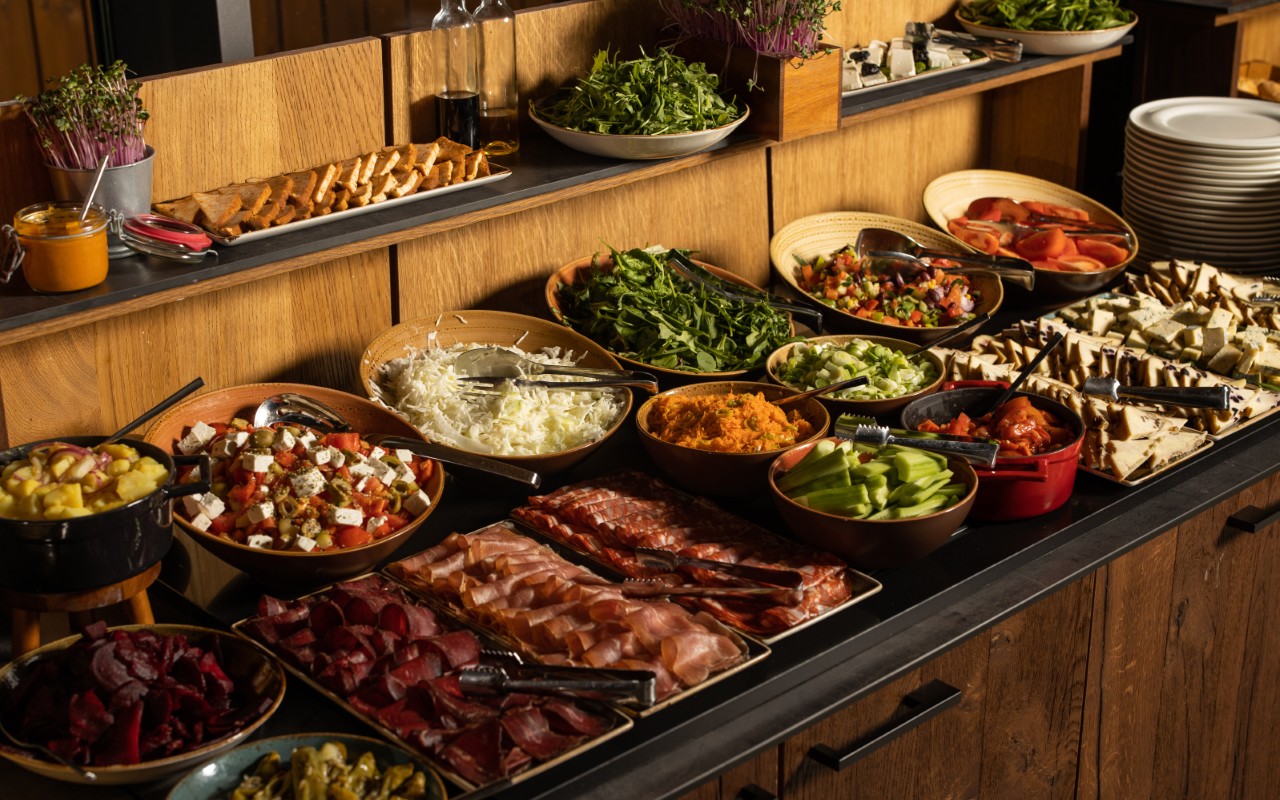 Buffet with assorted salads and cold cuts.