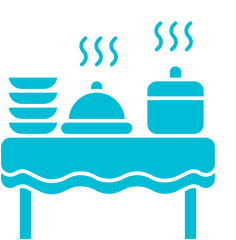 Table with steaming food and dishes.