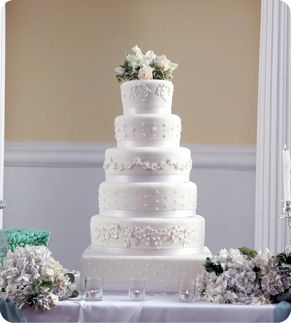 Elegant five-tier white wedding cake display.