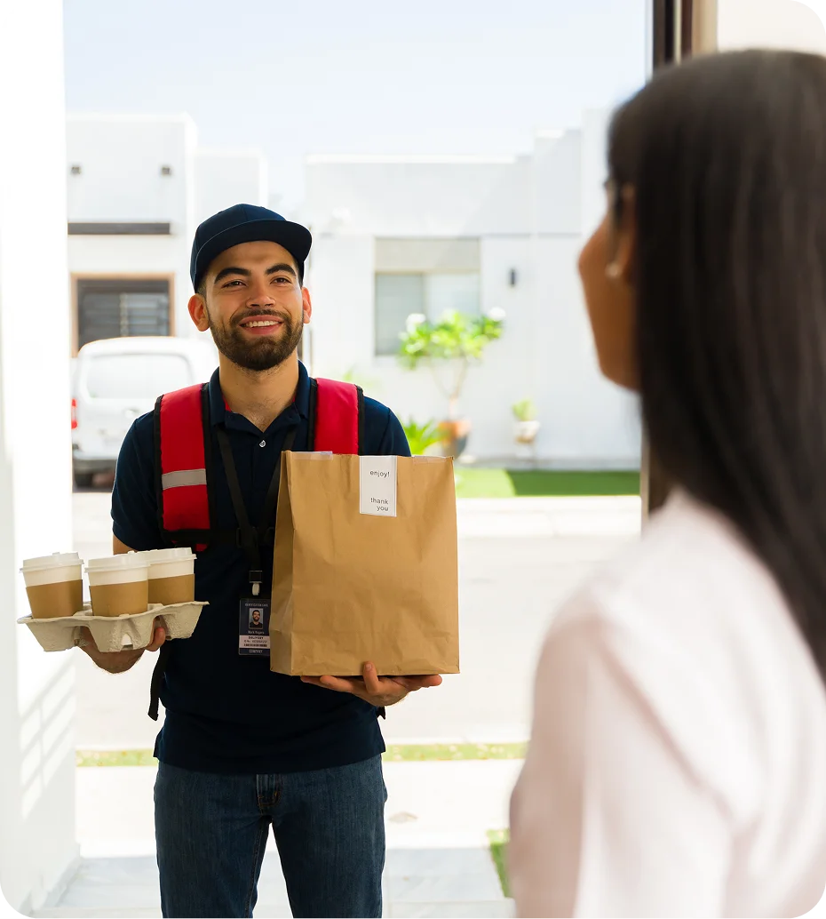 Delivery person handing over food and drinks.