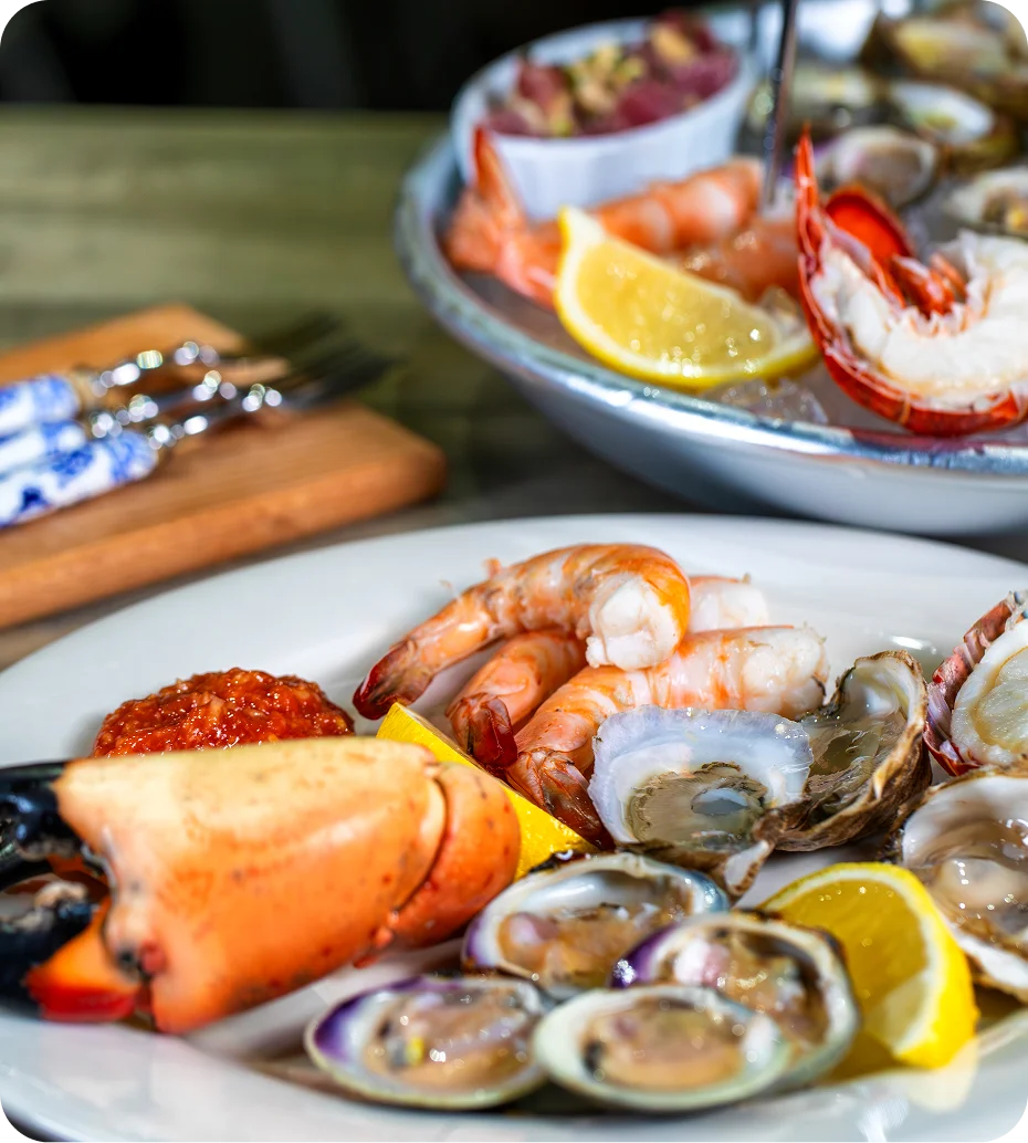 Seafood platter with shrimp and lemon slices.