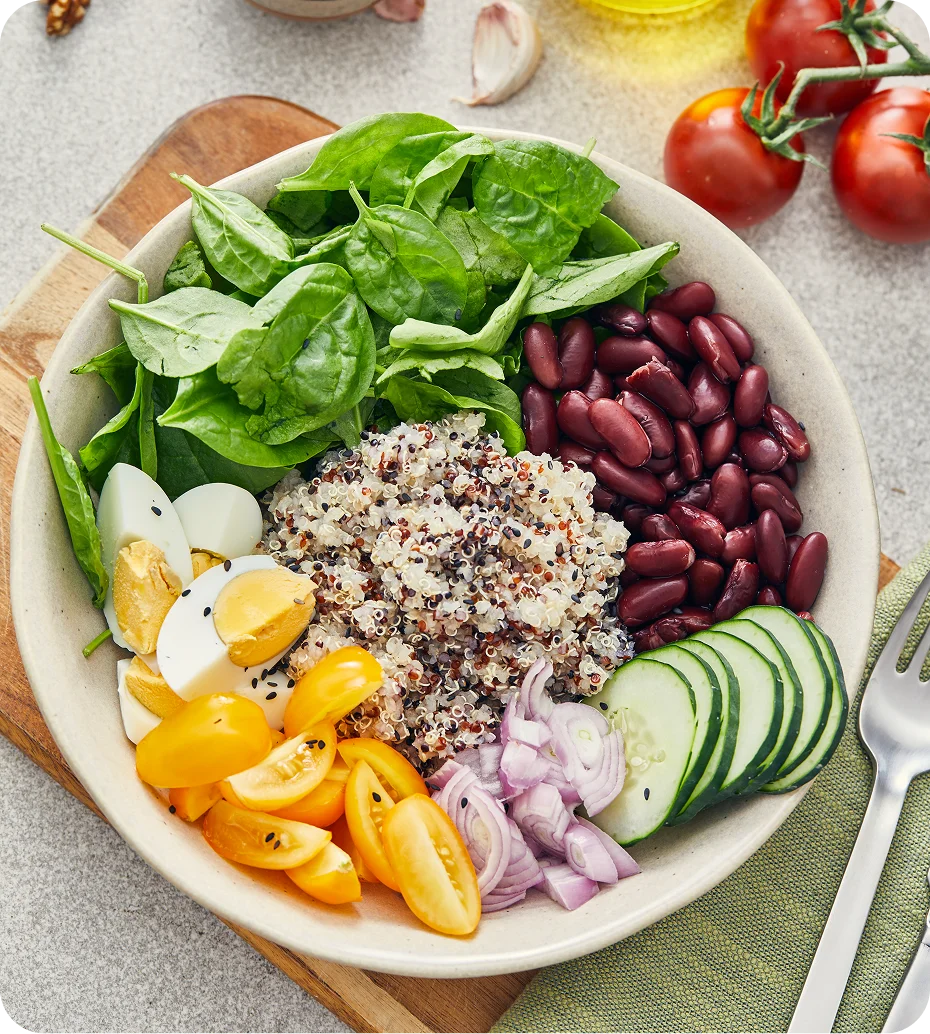 Salad bowl with quinoa, vegetables, and eggs.